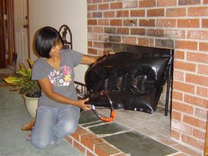 Denver Home Inspection A Woman holding a fireplace plug